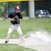 Milan sophomore Thomas Lindeman drops a ball as a Richmond player slides into second on Friday, June 14. Daniel Brenner I AnnArbor.com